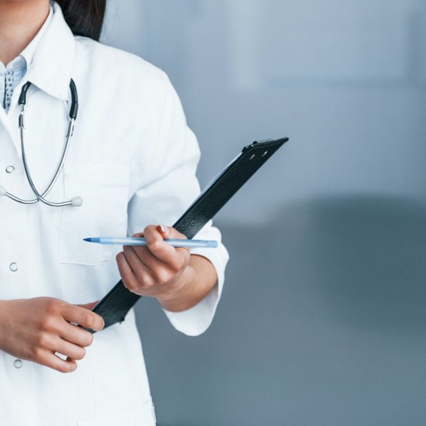 Friendly young nurse indoors in modern clinic ready to help you